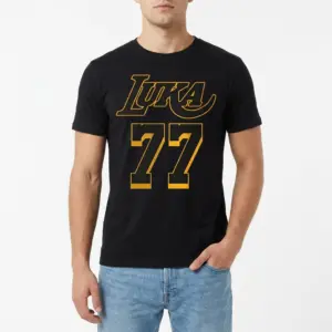 Retro Luka 77 Basketball Graphic T-Shirt 8 Detailed view of the yellow "LUKA" script and block "77" numbers on the front of a black t-shirt.