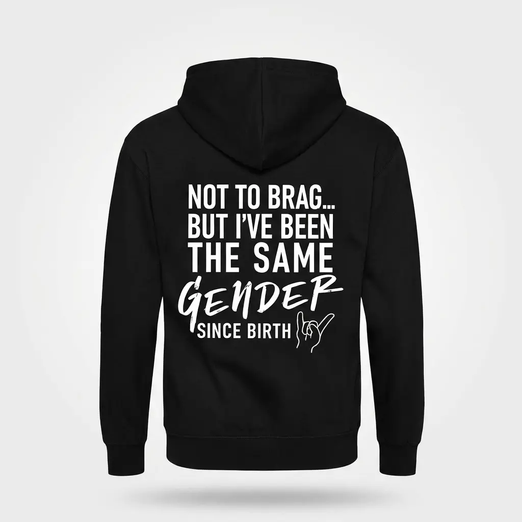 Flat lay of the back of a black hoodie displaying the sarcastic 'SAME GENDER SINCE BIRTH' design in white print.