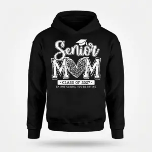 Senior Mom Class of 2027 Funny Graduation T-Shirt 7 Black hoodie flatlay featuring the 'Senior MOM Class of 2027' design, with a leopard print heart in 'MOM' and 'I'M NOT CRYING, YOU'RE CRYING'.
