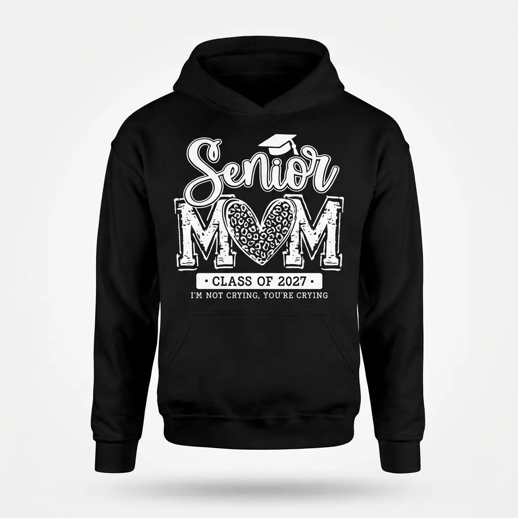 Black hoodie flatlay featuring the 'Senior MOM Class of 2027' design, with a leopard print heart in 'MOM' and 'I'M NOT CRYING, YOU'RE CRYING'.