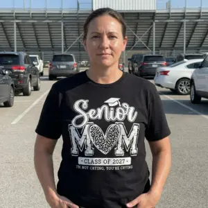 Senior Mom Class of 2027 Funny Graduation T-Shirt 10 Black t-shirt with the 'Senior MOM Class of 2027 I'M NOT CRYING, YOU'RE CRYING' design, suitable for graduation celebrations.