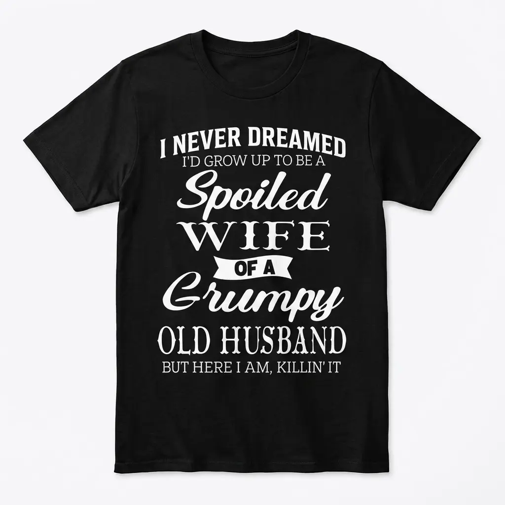Spoiled Wife of a Grumpy Husband T-Shirt 1 Flatlay of a black T-shirt with humorous white text about a spoiled wife.