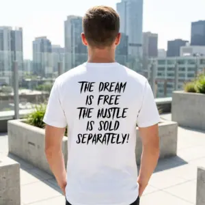 The Dream Is Free Hustle Motivational T-Shirt 10 White motivational t-shirt with black text reading 'THE DREAM IS FREE THE HUSTLE IS SOLD SEPARATELY!' displayed in a lifestyle setting.