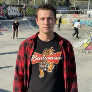 Vintage Budweiser Tiger Beer Logo Graphic T-Shirt 10 A person wears the black t-shirt, highlighting the fierce vintage Budweiser tiger design for a retro streetwear style.