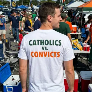 Vintage Catholics vs Convicts Football Shirt 11 Model wearing the vintage Catholics vs Convicts shirt in a casual outdoor setting.