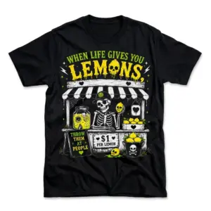 Flat lay of a black t-shirt with a sarcastic skeleton lemon stand graphic reading When Life Gives You Lemons, Throw Them At People.