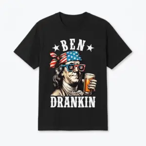 Flat lay of a black t-shirt featuring Benjamin Franklin in an American flag bandana and sunglasses holding a beer with text Ben Drankin.