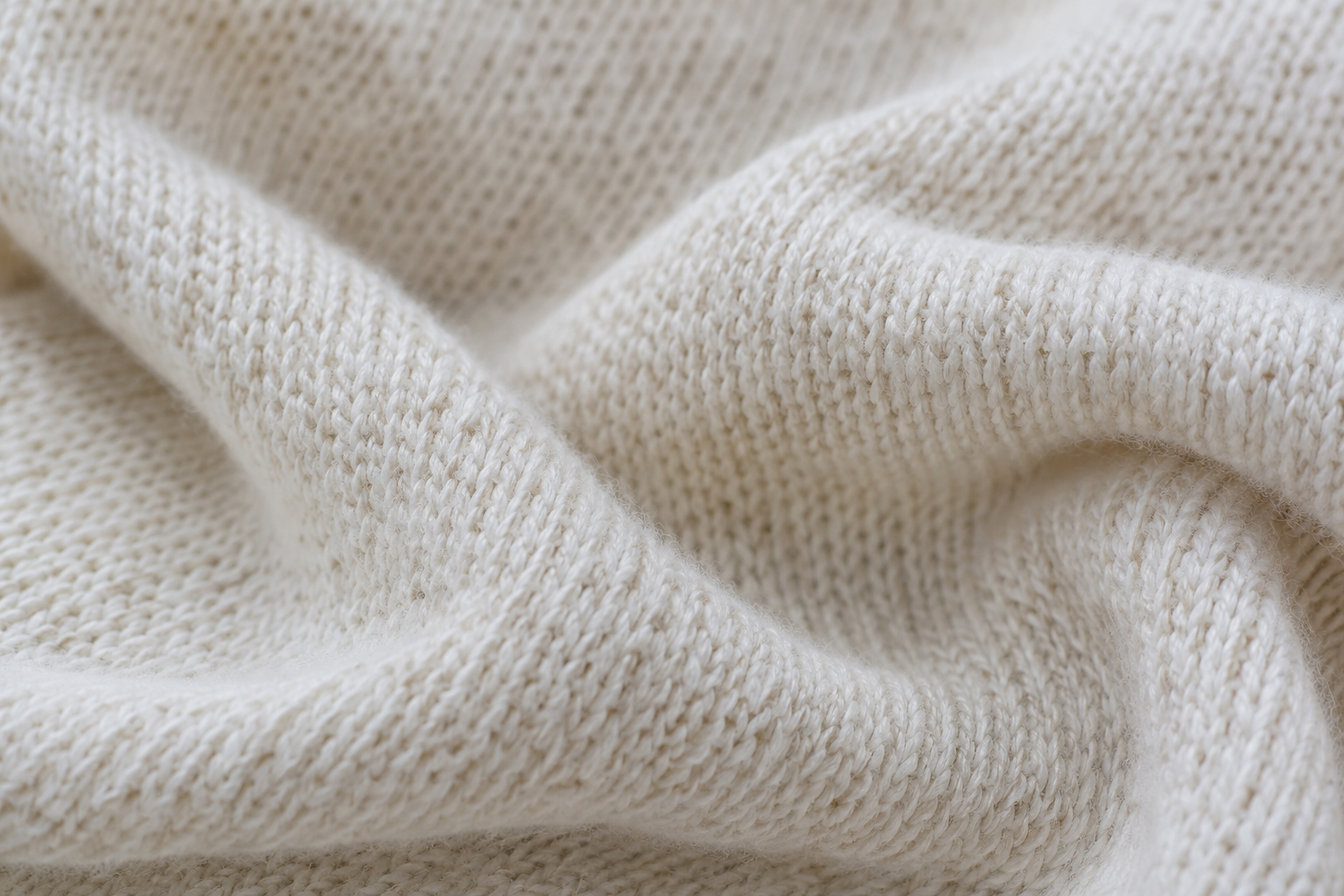 Does Cotton Shrink? What to Expect and How to Choose the Right Size 2 Close-up of ivory knit fabric in soft folds