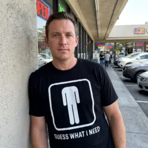 Funny Bathroom Sign Guess What I Need T-Shirt 11 Lifestyle view showing the Guess What I Need bathroom sign design on the product.