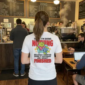 Funny Lazy Cat Doing Nothing T-Shirt 10 Lifestyle setting displaying the back design of the funny lazy cat shirt with lounging illustration and quote.