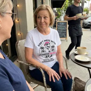 Don't Mess With Grandmasaurus You'll Get Jurasskicked Tee 11 Close-up casual look showcasing white tee and white tee front print reading DONT MESS WITH GRANDMASAURUS YOULL GET JURASSKICKED with a T-Rex wearing a