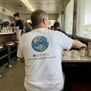 Earth One Star Review Would Not Recommend Funny T-Shirt 11 Close-up casual look showcasing white tee and back print of planet Earth with a one star rating bar reading Would Not Recommend Existing Here