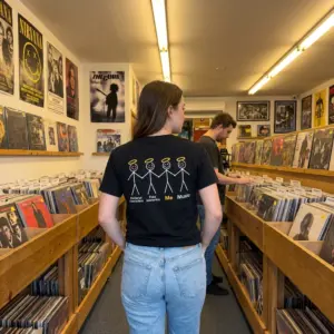 Fictional Characters Fake Scenarios Me Music T-Shirt 10 Everyday streetwear outfit styling black shirt with black tee back print showing four stick figures with golden halos labeled Fictional characters Fake