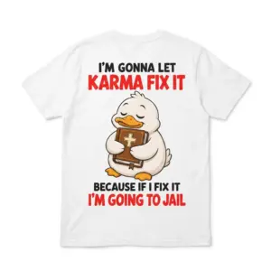 Back flat lay of a T-shirt featuring a duck holding a Bible and the text “I’M GONNA LET KARMA FIX IT” and “I’M GOING TO JAIL”