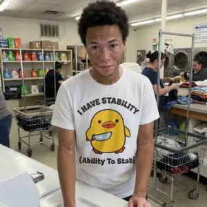 Funny I Have Stability Chick Graphic T-Shirt 10 Lifestyle view showing the humorous I Have Stability shirt featuring a cute chick holding a knife graphic.