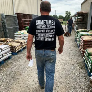 Funny Throw Cow Poop Sarcastic Farmer T-Shirt 10 Lifestyle setting showcasing the back of the sarcastic farmer t-shirt in casual wear.