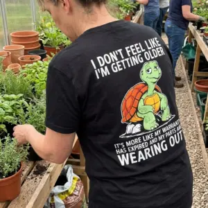 Funny Turtle Warranty Expired Getting Older T-Shirt 11 Casual lifestyle showcase highlighting the funny getting older apparel with a cartoon turtle and warranty expired message.