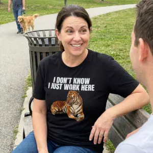 I Don't Know I Just Work Here Lounging Tiger T-Shirt 10 Everyday streetwear outfit styling black shirt with black tee front print reading I DONT KNOW I JUST WORK HERE above a lounging orange tiger