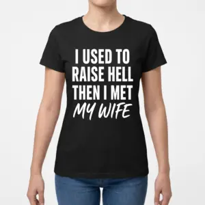 I Used to Raise Hell Then I Met My Wife T-Shirt 9 Woman modeling a shirt with the "I Used to Raise Hell Then I Met My Wife" typography on the front.