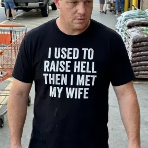I Used to Raise Hell Then I Met My Wife T-Shirt 10 Lifestyle shot displaying the funny husband shirt reading "I Used to Raise Hell Then I Met My Wife".