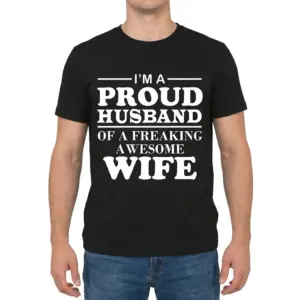 I'm A Proud Husband Of A Freaking Awesome Wife Black T-Shirt 9 Man wearing black graphic tee with black tee front print reading IM A PROUD HUSBAND OF A FREAKING AWESOME WIFE in bold white serif lettering