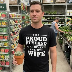 I'm A Proud Husband Of A Freaking Awesome Wife Black T-Shirt 10 Everyday streetwear outfit styling black shirt with black tee front print reading IM A PROUD HUSBAND OF A FREAKING AWESOME WIFE in bold white serif lettering