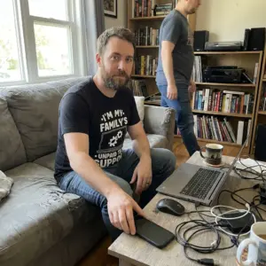 I'm My Family's Unpaid Tech Support Funny T-Shirt 10 Lifestyle view of the I'm My Family's Unpaid Tech Support t-shirt.