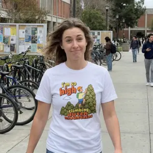 I'm So High Climbing Dutch Mountains Funny Pun T-Shirt 10 Everyday streetwear outfit styling white shirt with white tee front print reading i'm so high climbing dutch mountains with a cartoon hiker climbing green