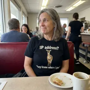 IP Address They Know Where I Pee Funny Deer Pun T-Shirt 11 Close-up casual look showcasing black tee and black tee front print reading IP address They know where I pee with a standing brown deer