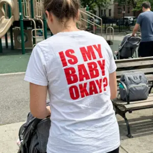Is My Baby Okay Bold Red Back Print Funny Parent T-Shirt 10 Everyday streetwear outfit styling white shirt with white tee back print reading IS MY BABY OKAY in oversized bold red block letters