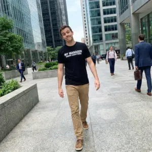 My Manager Knows Everything Sarcastic Office T-Shirt 10 Everyday streetwear outfit styling black shirt with black tee front print reading MY MANAGER KNOWS EVERYTHING in clean bold white block letters