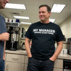 My Manager Knows Everything Sarcastic Office T-Shirt 11 Close-up casual look showcasing black tee and black tee front print reading MY MANAGER KNOWS EVERYTHING in clean bold white block letters