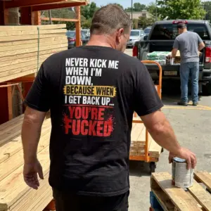 Never Kick Me When I'm Down When I Get Back Up T-Shirt 11 Close-up casual look showcasing black tee and black tee back print reading NEVER KICK ME WHEN IM DOWN BECAUSE WHEN I GET BACK UP YOURE FUCKED
