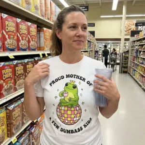 Proud Mother of Dumbass Kids Frog Disco T-Shirt 10 Lifestyle setting showing the proud mother frog shirt with its humorous crowned frog graphic.