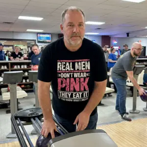 Real Men Don't Wear Pink They Eat It Funny T-Shirt 11 Casual lifestyle view of the real men dont wear pink shirt, displaying the edgy, grunge-style typography in a natural setting.
