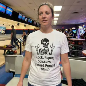 Rock Paper Scissors Throat Punch Funny Skeleton T-Shirt 11 Everyday lifestyle view highlighting the funny skeleton Rock Paper Scissors Throat Punch graphic apparel.