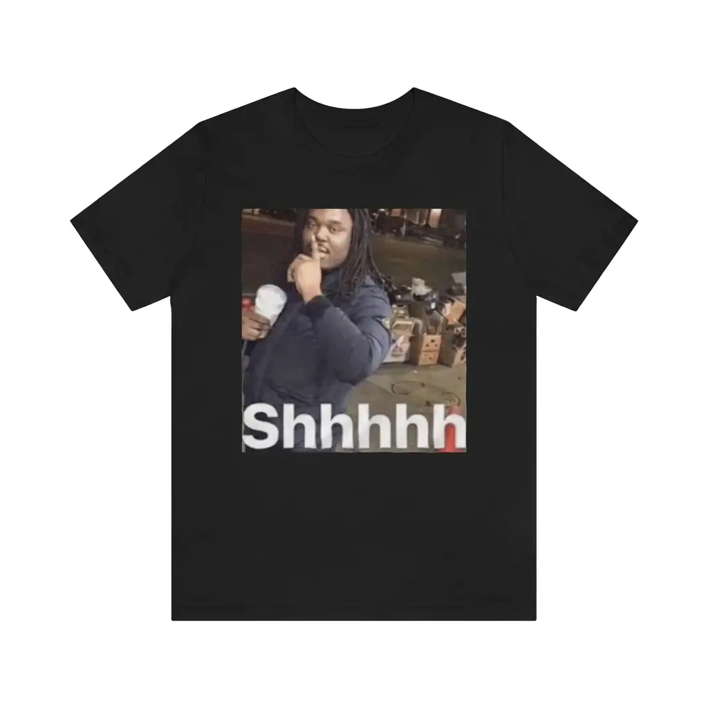 Shhhhh Quiet Street Meme Viral Reaction Graphic Black T-Shirt 1 Flatlay black t-shirt featuring black tee front print showing the viral Shhhhh street meme photo of a man holding a cup with finger to lips