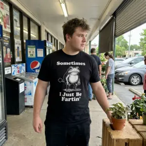 Sometimes I Just Be Fartin Funny Frog Graphic T-Shirt 10 Lifestyle presentation of the Sometimes I Just Be Fartin frog graphic shirt.
