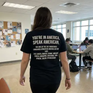 Speak American 381 Indigenous Languages Before 1492 T-Shirt 10 Candid outdoor rear photo of a wearer in the black Speak American 381 Indigenous Languages Before 1492 T-Shirt