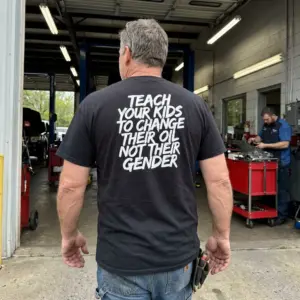 Teach Your Kids To Change Their Oil Not Their Gender T-Shirt 10 Everyday streetwear outfit styling black shirt with black tee back print reading TEACH YOUR KIDS TO CHANGE THEIR OIL NOT THEIR GENDER in white brush lettering
