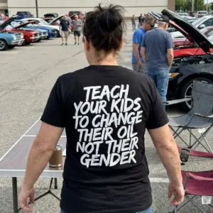 Teach Your Kids To Change Their Oil Not Their Gender T-Shirt 11 Close-up casual look showcasing black tee and black tee back print reading TEACH YOUR KIDS TO CHANGE THEIR OIL NOT THEIR GENDER in white brush lettering