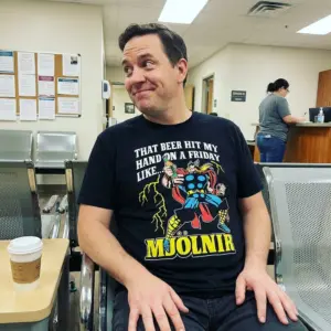 That Beer Hit My Hand On A Friday Like Mjolnir Funny T-Shirt 10 Everyday streetwear outfit styling black shirt with black tee front print reading THAT BEER HIT MY HAND ON A FRIDAY LIKE MJOLNIR with a comic thunder