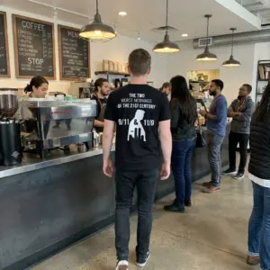 The Two Worst Mornings Of The 21st Century 9/11 11/9 T-Shirt 10 Candid outdoor rear view of a wearer in the black The Two Worst Mornings Of The 21st Century 9/11 11/9 T-Shirt