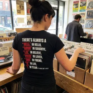 There's Always a Hell in Hello Sarcastic Wordplay T-Shirt 11 Close-up casual look showcasing black tee and black tee back print reading THERE'S ALWAYS A HELL IN HELLO GOOD IN GOODBYE LIE IN BELIEVE and I IN TEAM