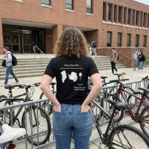 Things That Melt vs Things You Care About Melting T-Shirt 11 Close-up casual look showcasing black tee and black tee back print diagram reading Things That Melt with Greenland Antarctica and an ice cream cone