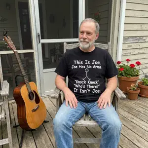 This Is Joe Joe Has No Arms Knock Knock Dark Humor T-Shirt 10 Candid photo of a man wearing the black This Is Joe Joe Has No Arms Knock Knock Dark Humor T-Shirt