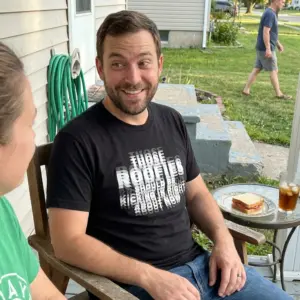 Those Roofies Should Be Kicking In Blurry Text Funny T-Shirt 10 Everyday streetwear outfit styling black shirt with black tee front print reading THOSE ROOFIES SHOULD BE KICKING IN RIGHT ABOUT NOW in blurry layered text