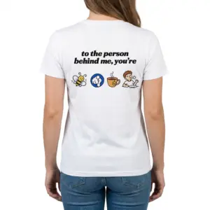 To the Person Behind Me Rebus Puzzle Funny T-Shirt 11 Woman wearing white cotton tee with back print reading to the person behind me you're with bee pointing finger tea cup and full cartoon icons