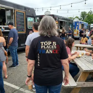 Top 5 Places To Visit In France Blank List Funny T-Shirt 11 Close-up casual look showcasing black tee and black tee back print reading TOP 5 PLACES TO VISIT IN FRANCE with landmarks above an empty list 1 to 5