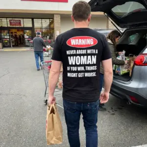 Warning Never Argue With A Woman Funny Marriage Humor Tee 11 Everyday street photo showing the back print of the black Warning Never Argue With A Woman relationship joke shirt